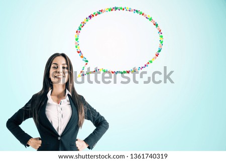 Happy young european businesswoman with creative colorful hand gesture speech bubble on blue background. Social network and communication concept