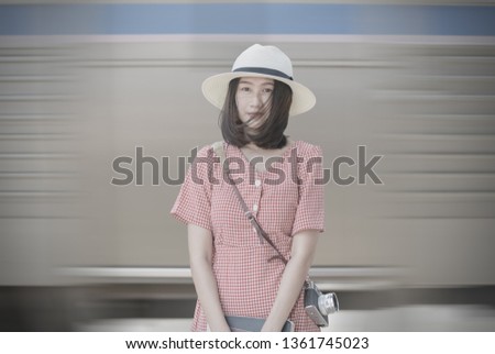 Hipster young traveler stand on blured train background, Vintage tone and Travel concept