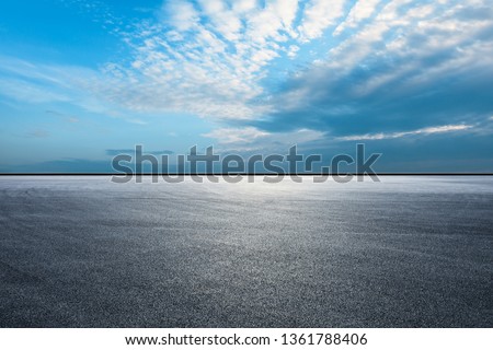 Empty asphalt race track ground and beautiful sky clouds  Royalty-Free Stock Photo #1361788406