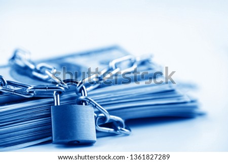 Business safety or financial protection or restriction access. Heap of money in chain with padlock isolated on white Royalty-Free Stock Photo #1361827289