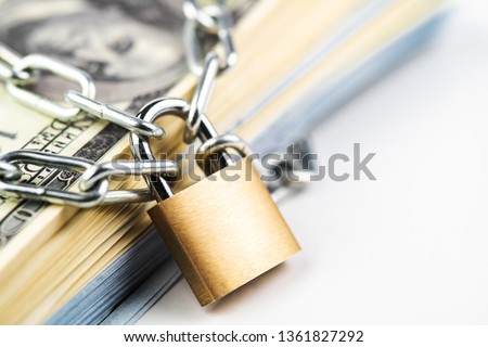 Business safety or financial protection or restriction access. Heap of money in chain with padlock isolated on white Royalty-Free Stock Photo #1361827292