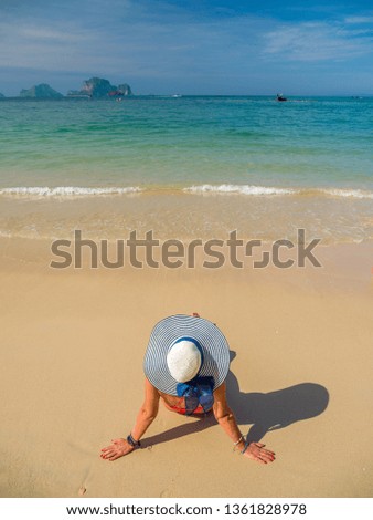 Woman enjoying her holidays at the tropical beach in Thailand - UNRETOUCHED body.