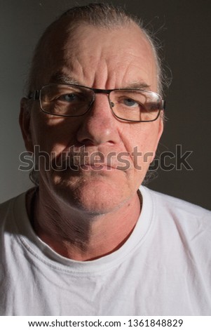 Close up portrait of older mature man. Head shot blank expression. Retirement theme.