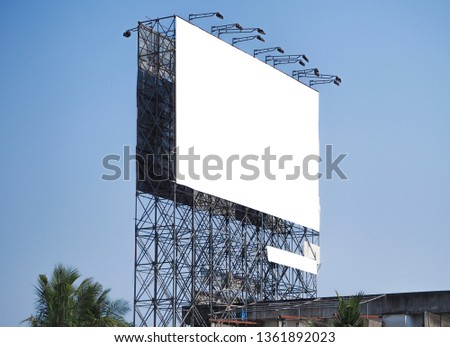 
Advertising large outdoor white billboard and blue sky background.