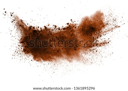 Explosion of deep brown powder on white background.