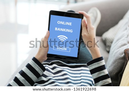 Hand using digital tablet with online bank account password login on screen over blur background, online banking cyber security concept