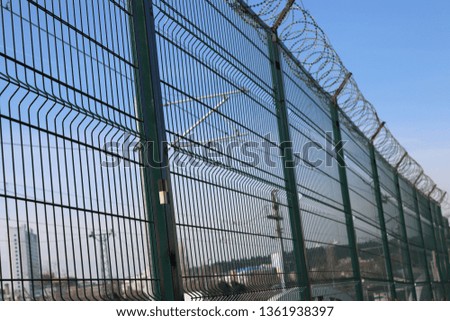 razor wire mesh
 Royalty-Free Stock Photo #1361938397