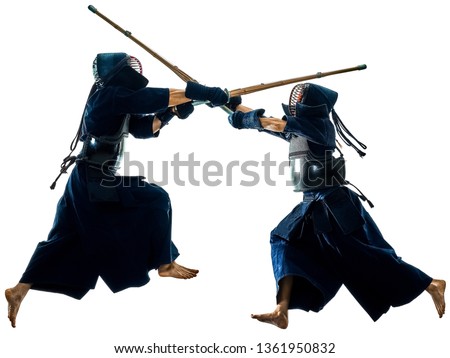 two Kendo martial arts fighters combat fighting in silhouette isolated on white bacground Royalty-Free Stock Photo #1361950832