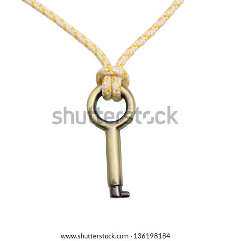 A Brass key hanging by a thread isolated over white background