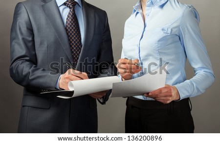 Businessman signing contract/document, grey background