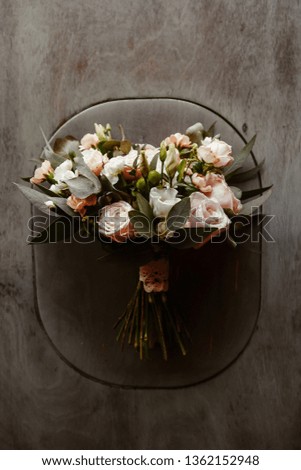 A beautiful bridal bouquet lies on a wooden gray surface. View from above