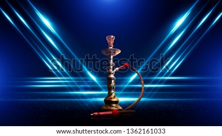 Hookah smoking on a dark abstract background. Background of empty scenes with neon lights and colored lights, reflection of night lights on wet asphalt