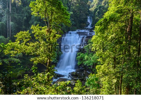Water fall in spring season located in deep rain forest jungle.