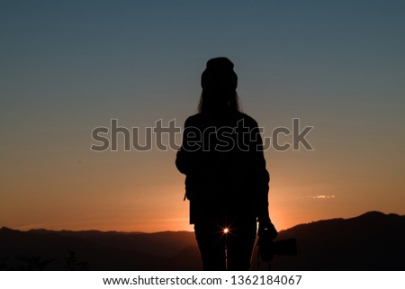 The silhouette of climbing with the camera looking at the sunset