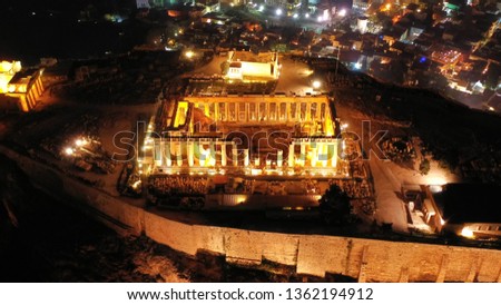 Aerial drone night panoramic shot of iconic illuminated landmark Acropolis hill and the Masterpiece of Ancient times and Western civilisation - the Parthenon, Athens, Attica, Greece