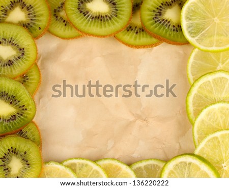 Lime and kiwi fruit slices frame on color background