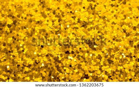 Confetti Gold tinsel scattered in the background and texture. The concept of a brilliant holiday and luxurious fun.
