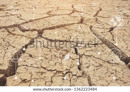Dry and cracked land with icons about environment on image. Crack dried soil in drought, Affected of global warming made climate change. Water shortage and drought concept.