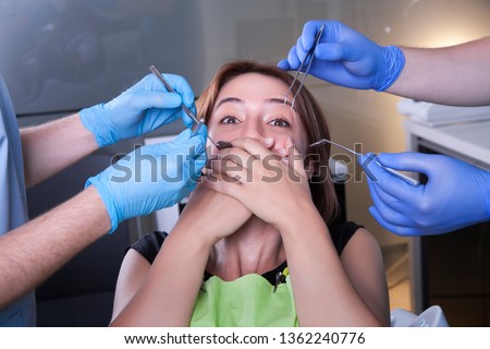 Woman patient scared of the dentist. Royalty-Free Stock Photo #1362240776