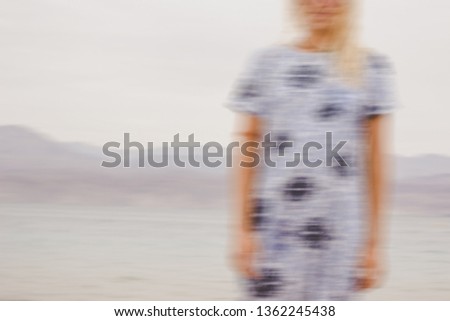 abstract unfocused female body silhouette in light dress outdoor natural environment 