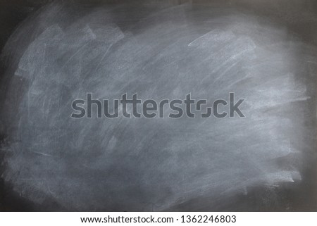 Black chalkboard texture with smudged and smeared  eraser marks.
