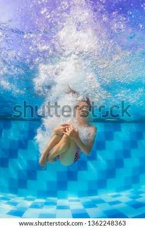 Happy family have fun in swimming pool. Funny child swim, dive in pool - jump deep down underwater from poolside. Healthy lifestyle, people water sport activity, swimming lessons on holidays with kids Royalty-Free Stock Photo #1362248363
