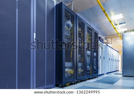 Server internet datacenter room with rows of modern mainframes. Server control center for internet provider. Network and technology concept. Royalty-Free Stock Photo #1362249995