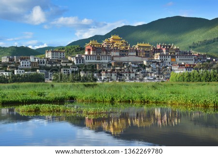 Ganden Songzanlin Complex reflecting in the lake. Shangri-La County, Yunnan province, China Royalty-Free Stock Photo #1362269780