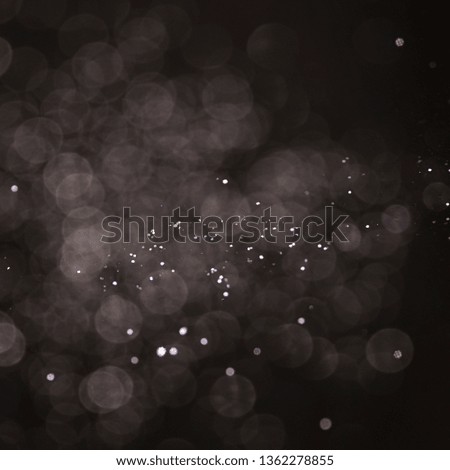 Texture background abstract black and white or silver Glitter and elegant for Christmas. Dust white. Sparkling magical dust particles. Magic concept. Abstract background with bokeh effect.