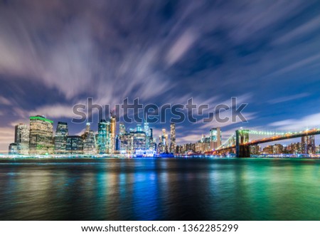 Manhattan panoramic skyline at night with Brooklyn Bridge. New York City, USA. Office buildings and skyscrapers at Lower Manhattan (Downtown Manhattan).

