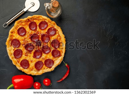 Tasty pepperoni pizza of tomatoes and ingredients on concrete background. Top view of hot pepperoni pizza.,copy space for your text