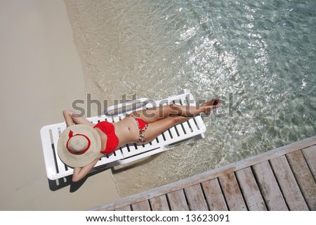 Pretty woman lying on the beach from an overhead perspective