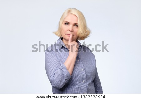 senior woman smirking thinking trying create plan in mind