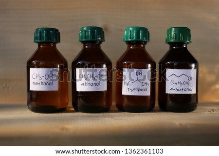 Polar protic solvents alcohols in dark glass bottles: methanol, ethanol, isopropanol, butanol. These substances are used as fuel additives to increase the octane number. Royalty-Free Stock Photo #1362361103