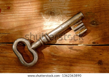 Old key on a wooden background