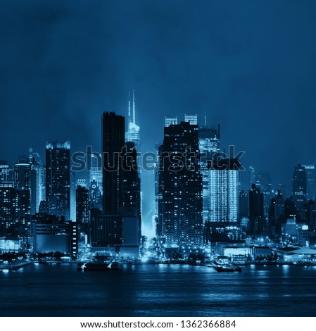 Manhattan midtown skyscrapers and New York City skyline at night with fog