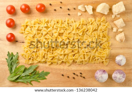 Italian pasta with ingredients on a wooden cutting board