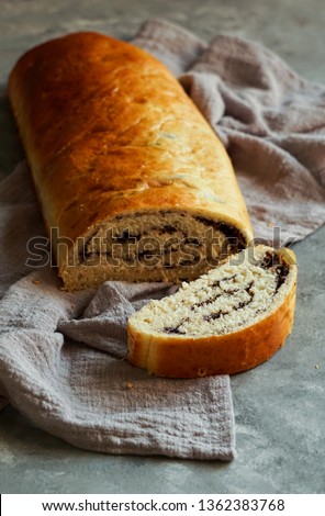   poppy seed Roll on a stone grey surface, closeup                             