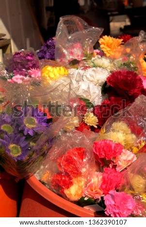 Picture of a booth with fresh and artificial flowers taken in Beer-Sheva (Israel) farmers market.
