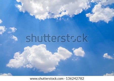 Sun ray shining through the clouds in the blue sky