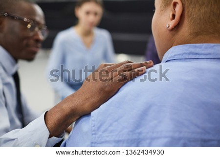 Closeup of unrecognizable African man comforting woman during group therapy session with psychologist, copy space Royalty-Free Stock Photo #1362434930