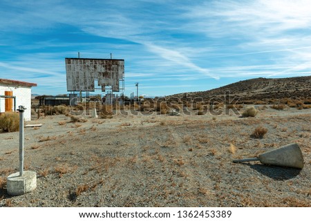 Abandoned drive in theatre with a broken screen Royalty-Free Stock Photo #1362453389