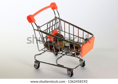 Shopping time with saving money over white background. Orange trolley.
