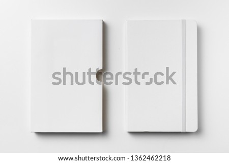 Design concept - top view of close white notebook with elastic band, case isolated on white background for mockup. real photo, not 3D render