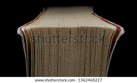 Macro image of worn corner of pages of a book.
