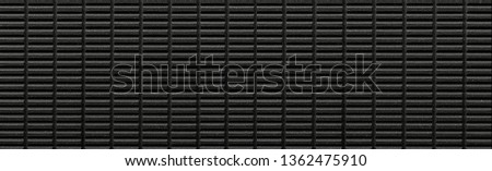 Panorama of Modern Black Stone tile wall texture and seamless background