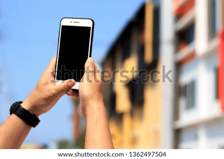 Man holding mobile smart phone using smart application for sale