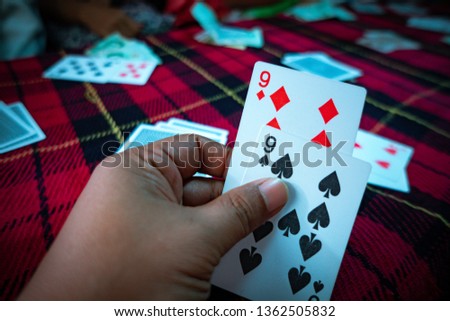 Blurred playing card in relaxing time, card in hand