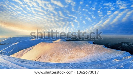 Mountain ridge sunset panorama view in golden-pastel tones from last evening sunrays (Ukraine, Carpathian Mt's, Drahobrat ski resort). Ten shots stitch image.