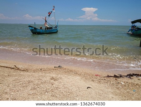 Tropical beach scenery with a natural composition of clear skies and small boats